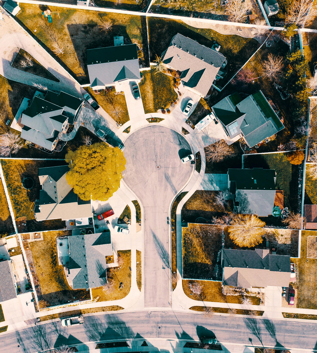 Aerial view of modern single-family homes in a planned suburban neighborhood, symbolizing thoughtful land development.