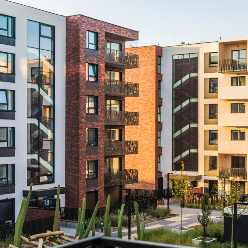 Abstract close-up of steel beams and concrete structures under sunlight, reflecting full-spectrum real estate project execution.