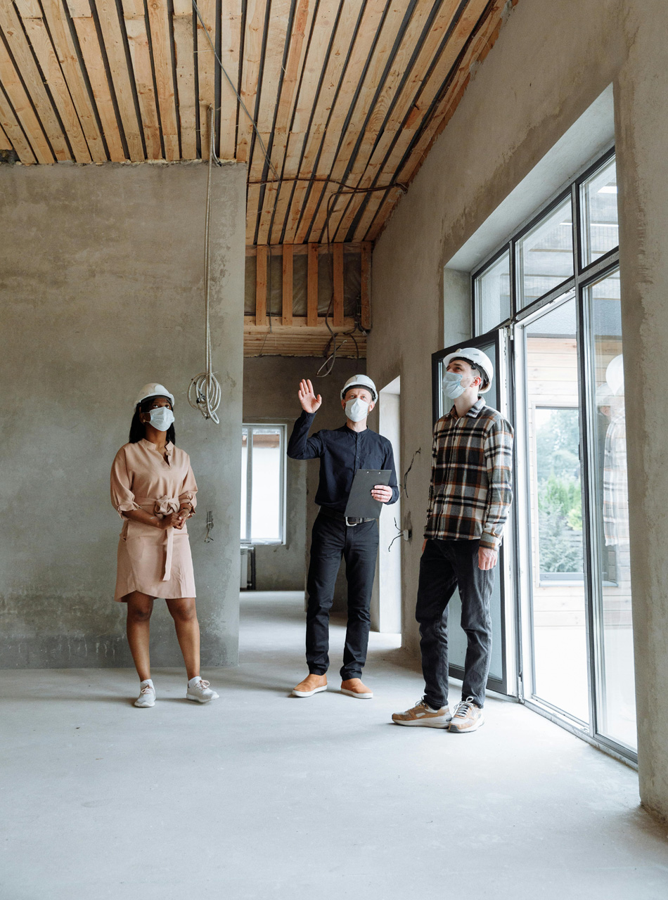 Team of professionals inspecting a residential construction site, symbolizing land development and project management.